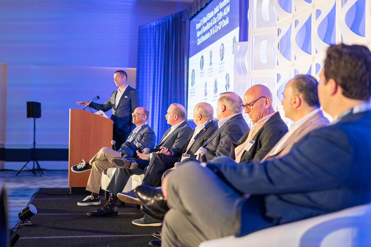 Panel of investors on stage at a Family Office Club summit