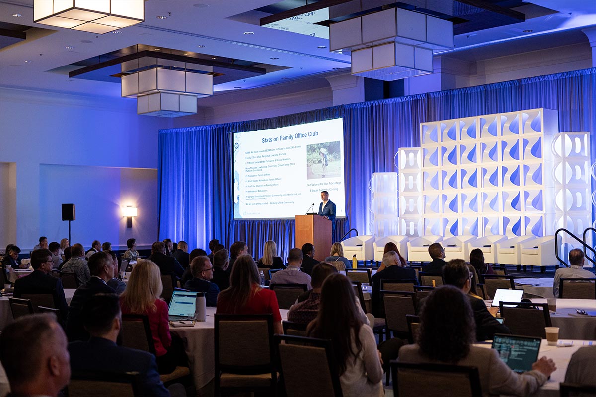 Speaker presenting to a ballroom audience