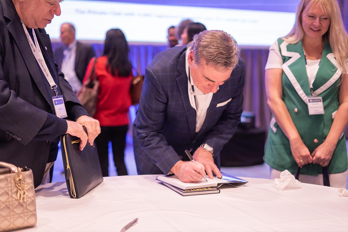 Richard C. Wilson signing a book for an attendee